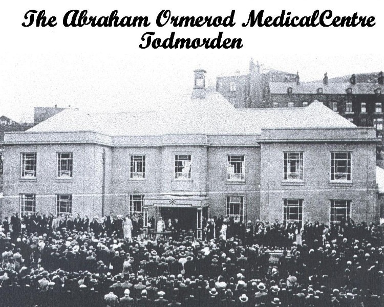 A black and white photograph from the opening of Abraham Ormerod medical centre, a podium is visible in front of the main entrance and the street is packed full of local people.